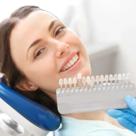 Close-up view of a dental implant model with a titanium post and attached crown, illustrating tooth replacement structure.